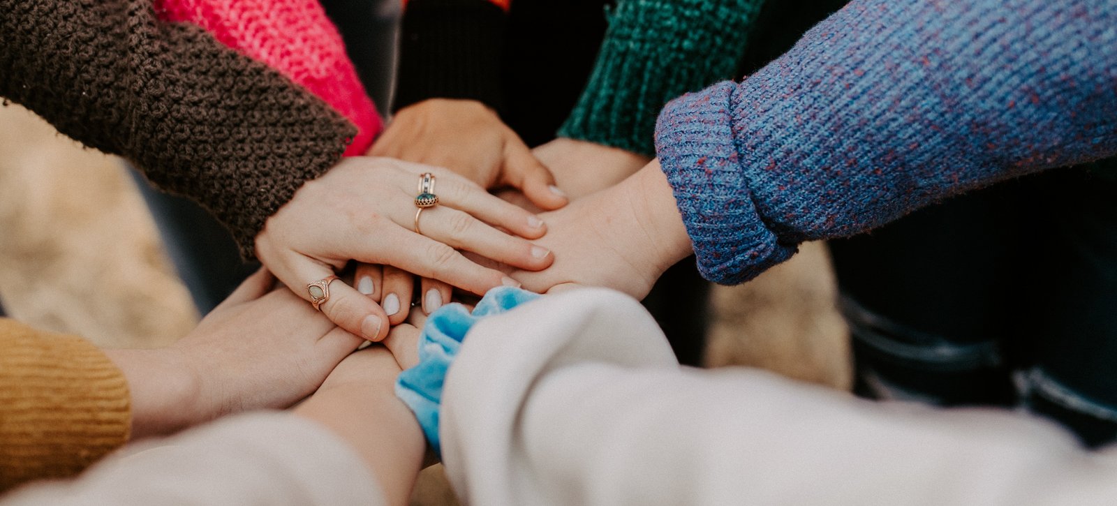 AStA Acht Hände von acht Menschen liegen aufeinander.
